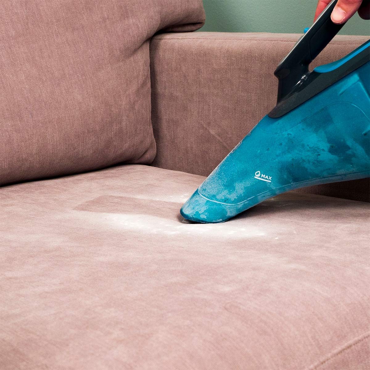 HH vacuuming up baking soda from upholstery