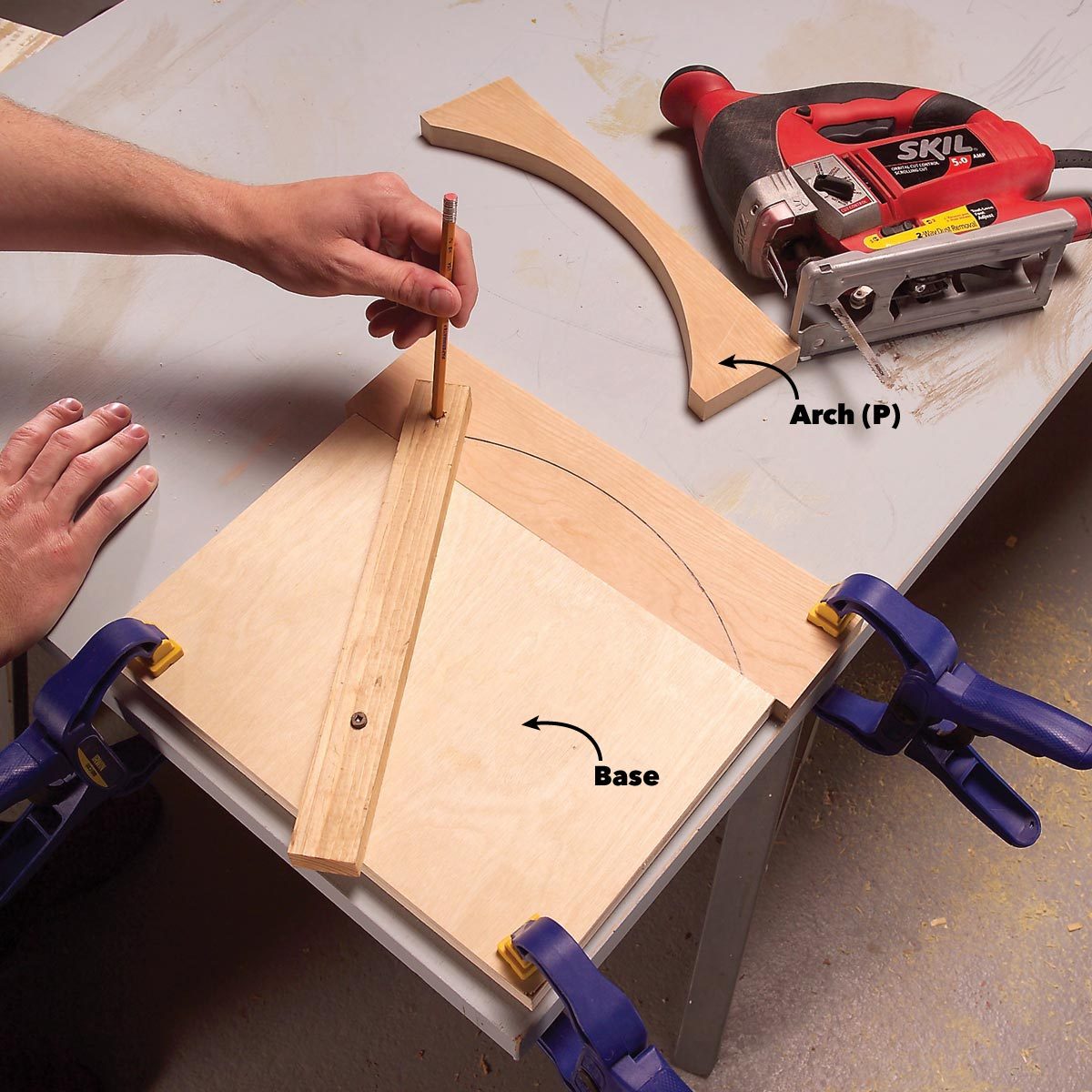 A hand holds a pencil, marking a curve on wood secured to a work table, while a jigsaw rests nearby, preparing for cutting.