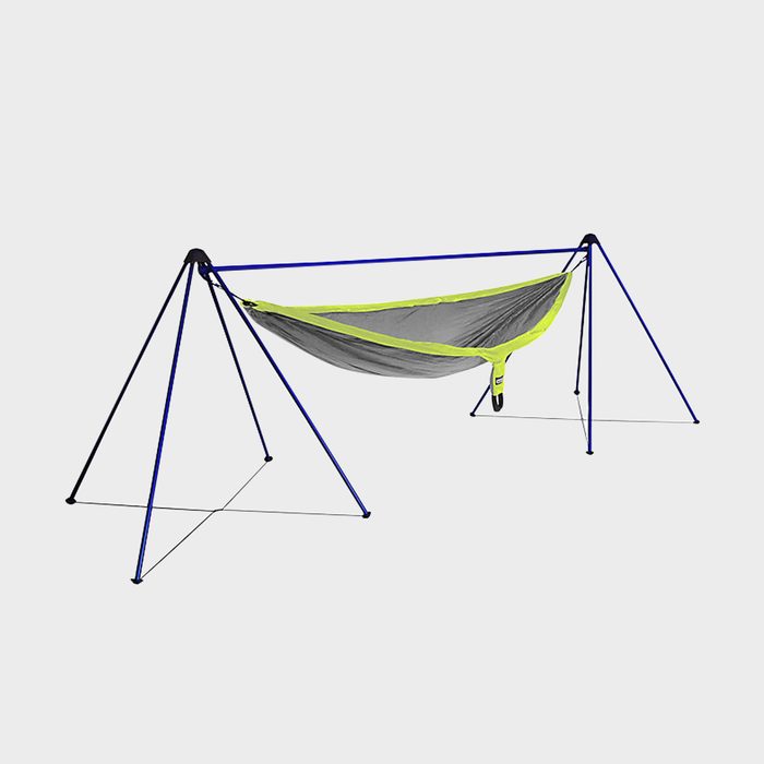 A gray and green hammock is suspended between blue and black supports, designed for relaxation or rest in outdoor or camping settings.