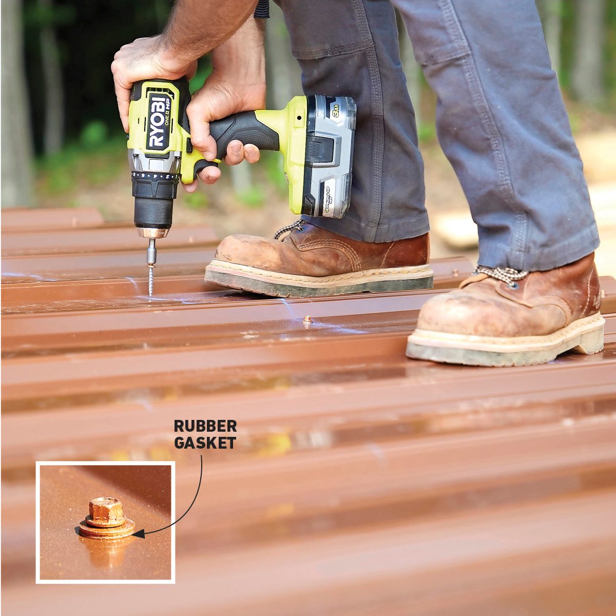 A person uses a power drill to secure a rubber gasket onto a brown metal surface while standing outdoors on a construction site.